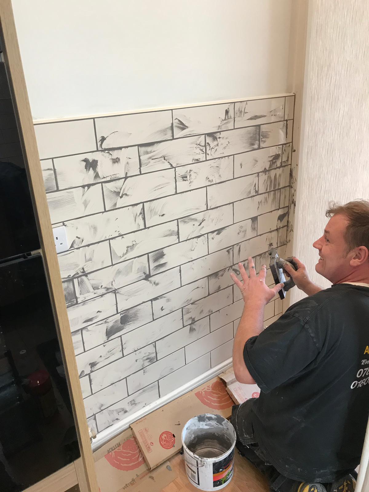 Kitchen wall being tiled
