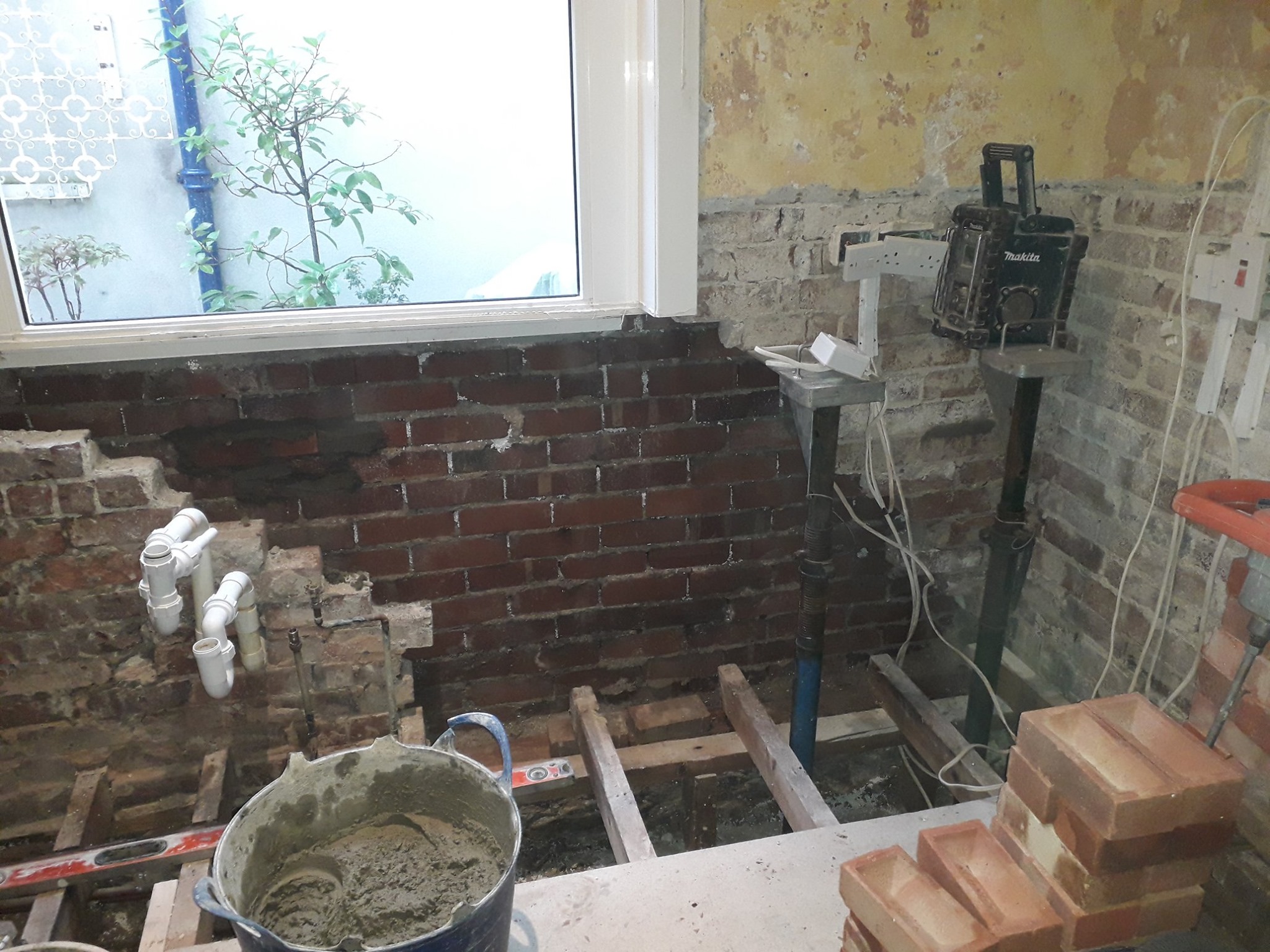 Damp brick wall being protected