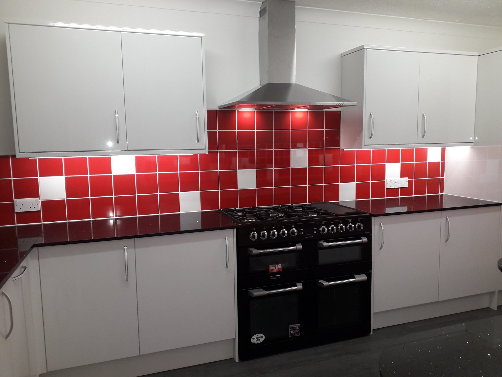 White kitchen build with red tiling