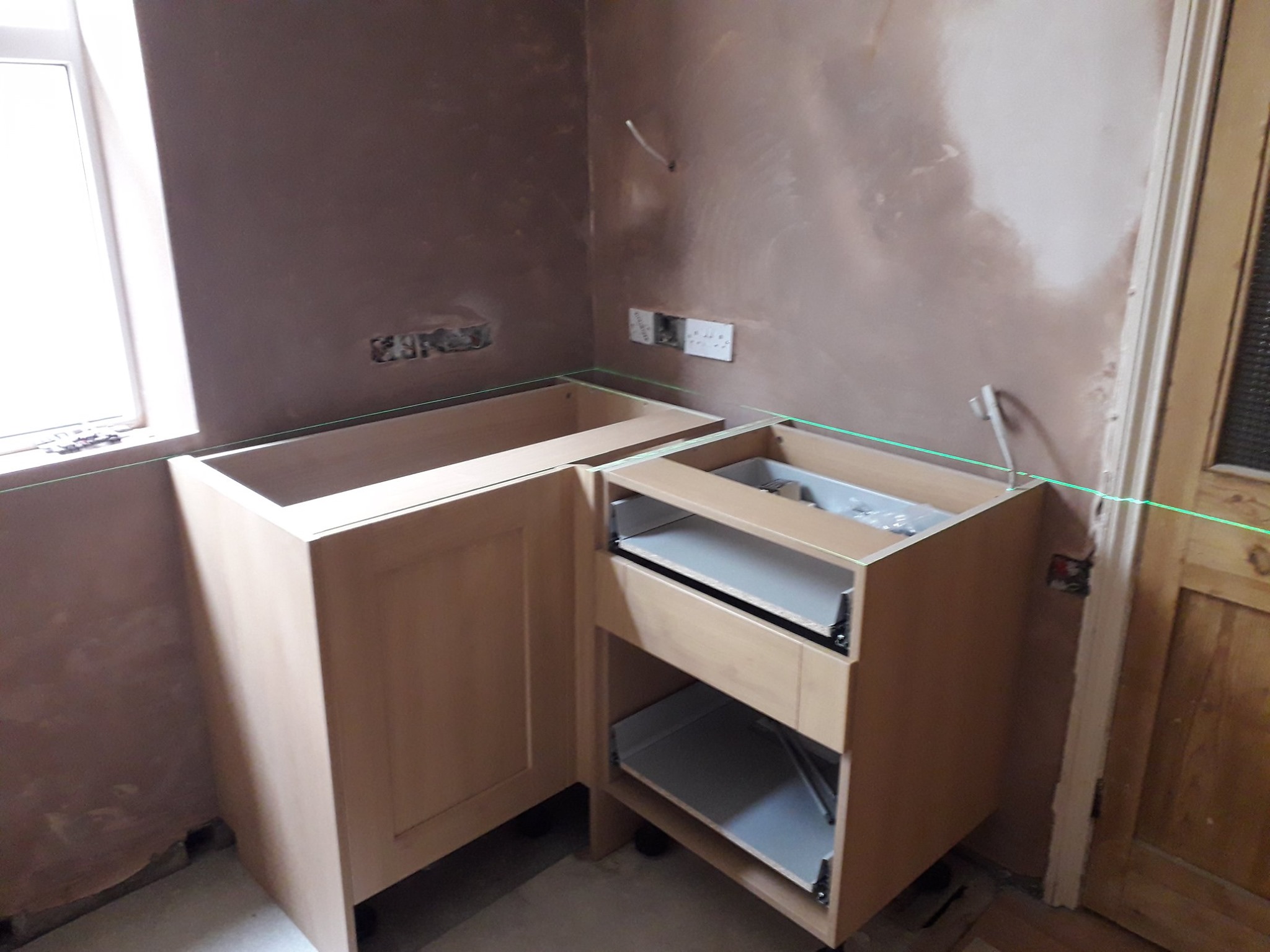Plastered wall with new kitchen units