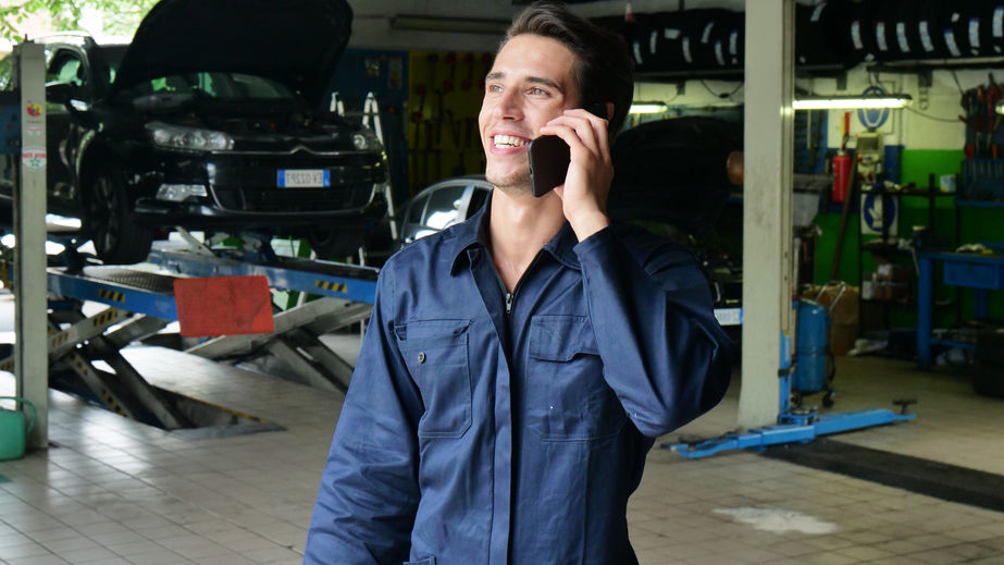 Mechanic taking a customers call