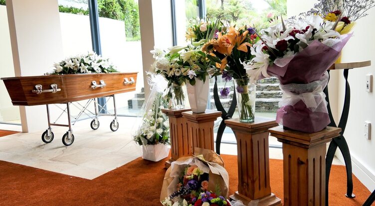 Coffin and floral tributes