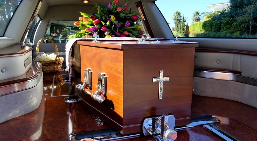 Coffin loaded into hearse